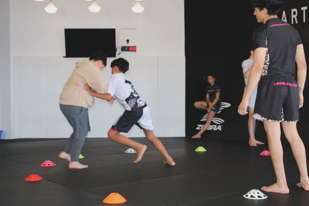 A member drilling a self-defense Brazilian Jiu-Jitsu position during No-Gi training at AOE in Monterey